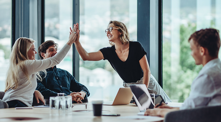 Women High-Five at conference table